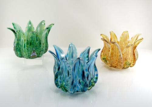Tea light candle holders. Solid sculpted glass. Available in many color options. Approx. 4"x 4"x 3"